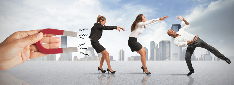 Two women in business attire are facing opposite directions.