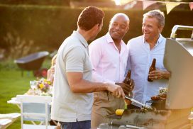 Three men are having a good time at the bbq.