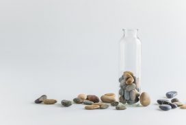 A glass bottle with rocks in it